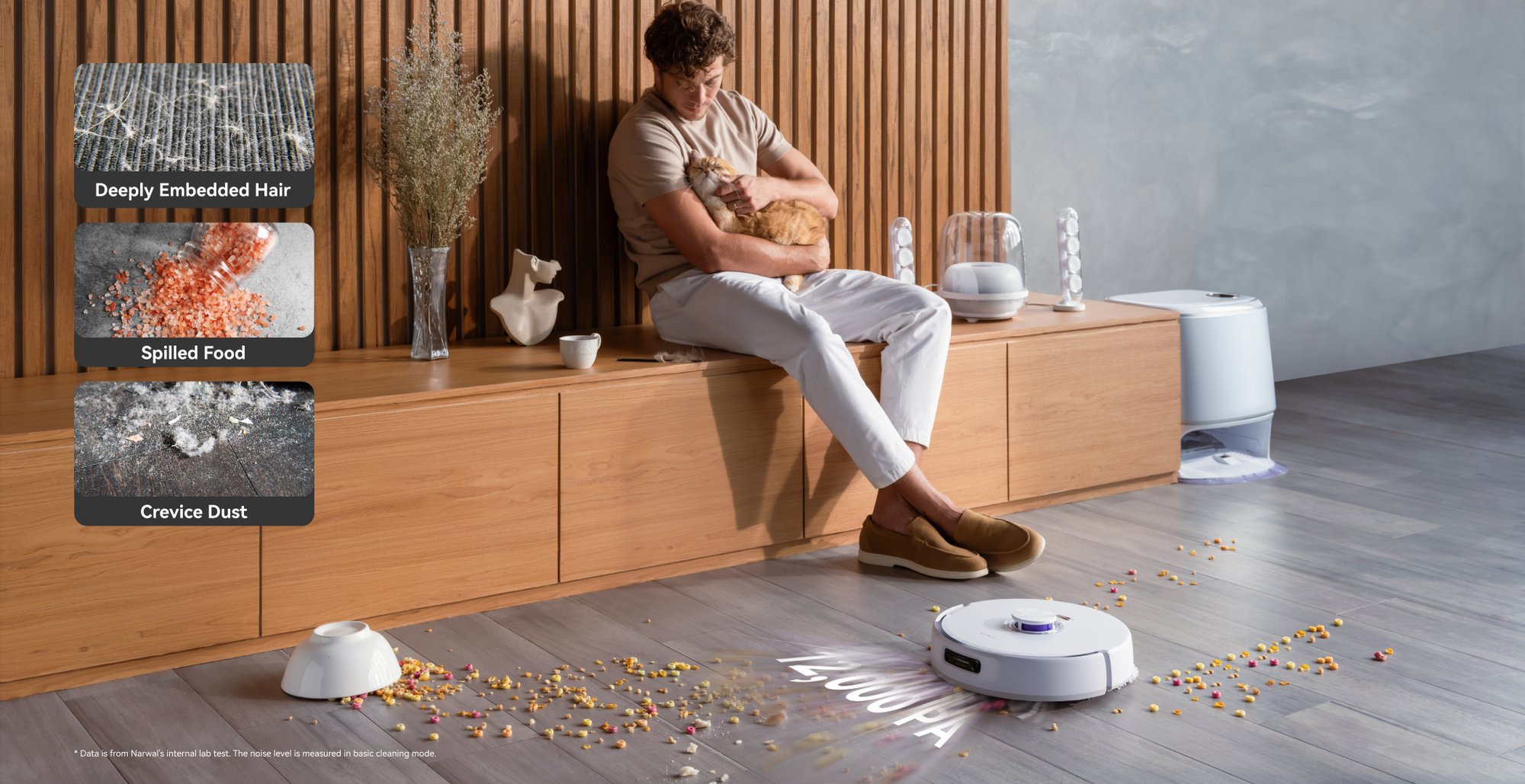 Narwal robot vacuum cleaning various messes while a person enjoys time with a cat.