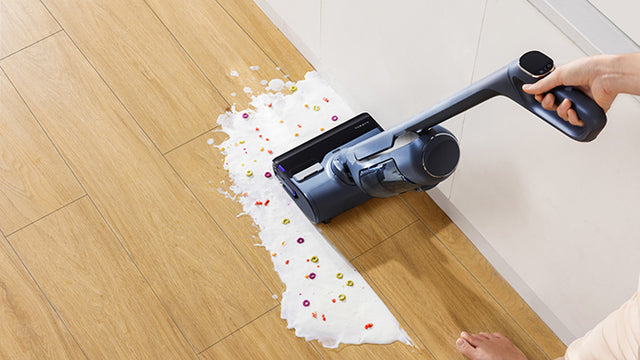 Narwal S20 Pro cordless vacuum mop efficiently cleaning up spilled milk and beads, showcasing its wet and dry cleaning capabilities.